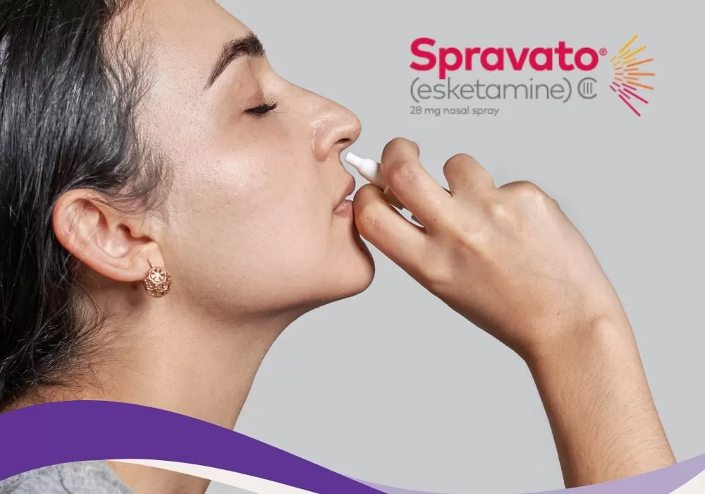 A patient self-administering Spravato nasal spray under clinical supervision.